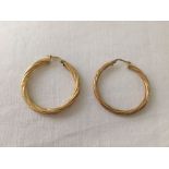 A pair of hallmarked 9ct gold hooped earrings. Weight approx 3g.