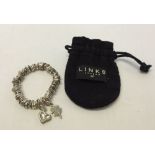 A Links of London silver sweetie bracelet with 2 charms attached.