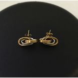 A pair of 9ct gold modern design, two-colour, interlinked oval ring design earrings with 9ct