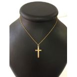 Gold cross with star design engraving, unmarked - tests as 9ct. On a 16" chain, possibly gold