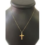 A 9ct gold engraved cross on an 18" gold chain. Weight approx 1.8g.