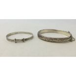 2 silver bangles, one a childs adjustable christening bangle and a hallmarked hinged bangle with