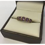 9ct gold dress ring set with five round amethysts. Size M.