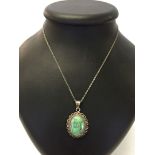 Silver pendant set with a large turquoise cabouchon on a 18" silver chain.