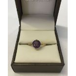 An 18ct gold ladies dress ring set with an amethyst. Size approx M½. Weight approx 2.3g.