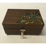 A boxed musical wooden jewellery box with painted garden decoration to lid. Plays 'Spring Song'.