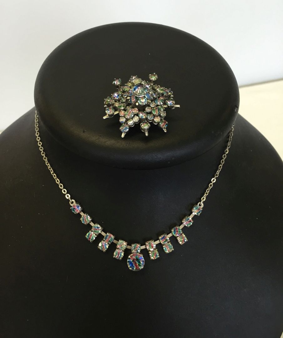 A vintage rainbow diamante necklace and matching brooch.