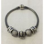 A Pandora oxidised silver charm bracelet complete with 5 charms to include Pave set.