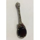 A 925 silver marcasite and garnet brooch in a mandoline/guitar design. Approx 7cm across.