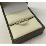 An 18ct gold diamond trilogy ring. Each stone approx 0.05 carat. Ring size M. Approx 1.8.