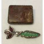 2 brooches: 1 marked sterling set with a pearl and red and green stones and 1 large agate brooch.