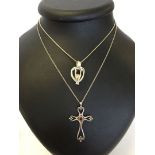 2 silver pendants on chains: one is a pretty open cross set with a Garnet. The other is a heart