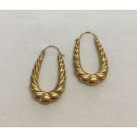 A large pair of 9ct gold elongated hoop earrings. Approx weight 1.8g.