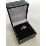 18ct gold dress ring set with a sapphire surrounded by 4 illusion set diamonds. Size P, approx