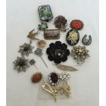 A collection of brooches to include micro mosaic and carved bogwood.