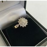 A 9ct gold diamond cluster ring. Total diamond weight 0.05ct, size M1/2. Total weight approx 2.4g