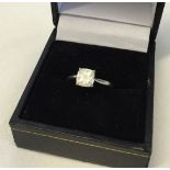 An 18ct white gold ring set with a princess cut solitaire mossanite (approx 1ct). Size K½.