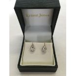 A pair of 9ct white gold earrings set with diamonds. Total weight approx 1.1g.