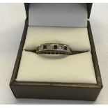 9ct gold eternity ring set with square cut sapphires and clear stones. Size I, approx 3.4g total