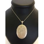 Large silver locket (5 x 4cm) on 20 inch silver chain, approx 27g.