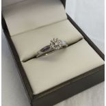 A 9ct white gold illusion set solitaire diamond ring. Size N.