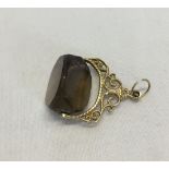 9ct gold fob with spinning smokey quartz stone.