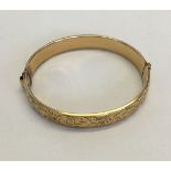 A 9ct gold bangle with base metal core.