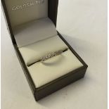 An 18ct gold & illusion set diamond half eternity ring. Size M. Approx 2.5g.