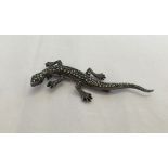 A silver and marcasite lizard brooch.