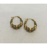 A pair of 9ct gold bi-colour hoop earrings. Total weight approx 1.6g.