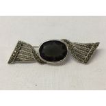 A 925 silver and marcasite bow brooch set with a large smokey quartz stone, approx 5.5cm across.