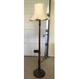 A dark oak decorative standard lamp with a cream shade.