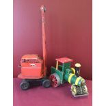 A Tri-ang tinplate red crane together with a wooden toy steamroller.