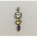 A 925 silver pendant set with a square pale blue topaz, an oval citrine and a teardrop amethyst.
