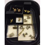 A collection of costume cufflinks, tie pins & tie bar.