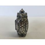 A owl shaped metal sovereign case.