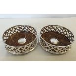 A pair of silver plated and wood coasters.