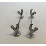 A pair of EPNS cockerel knife rests.