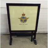 A tilt top table set with an embroidered RAF badge (approx 53cm high).