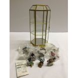 A glass display cabinet housing 'Garden Birds of the World' miniatures by Franklin Mint Ltd with