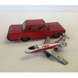 A c1960-70s tinplate Japanese car with a Japanese tinplate TWA Boeing 727 plane.