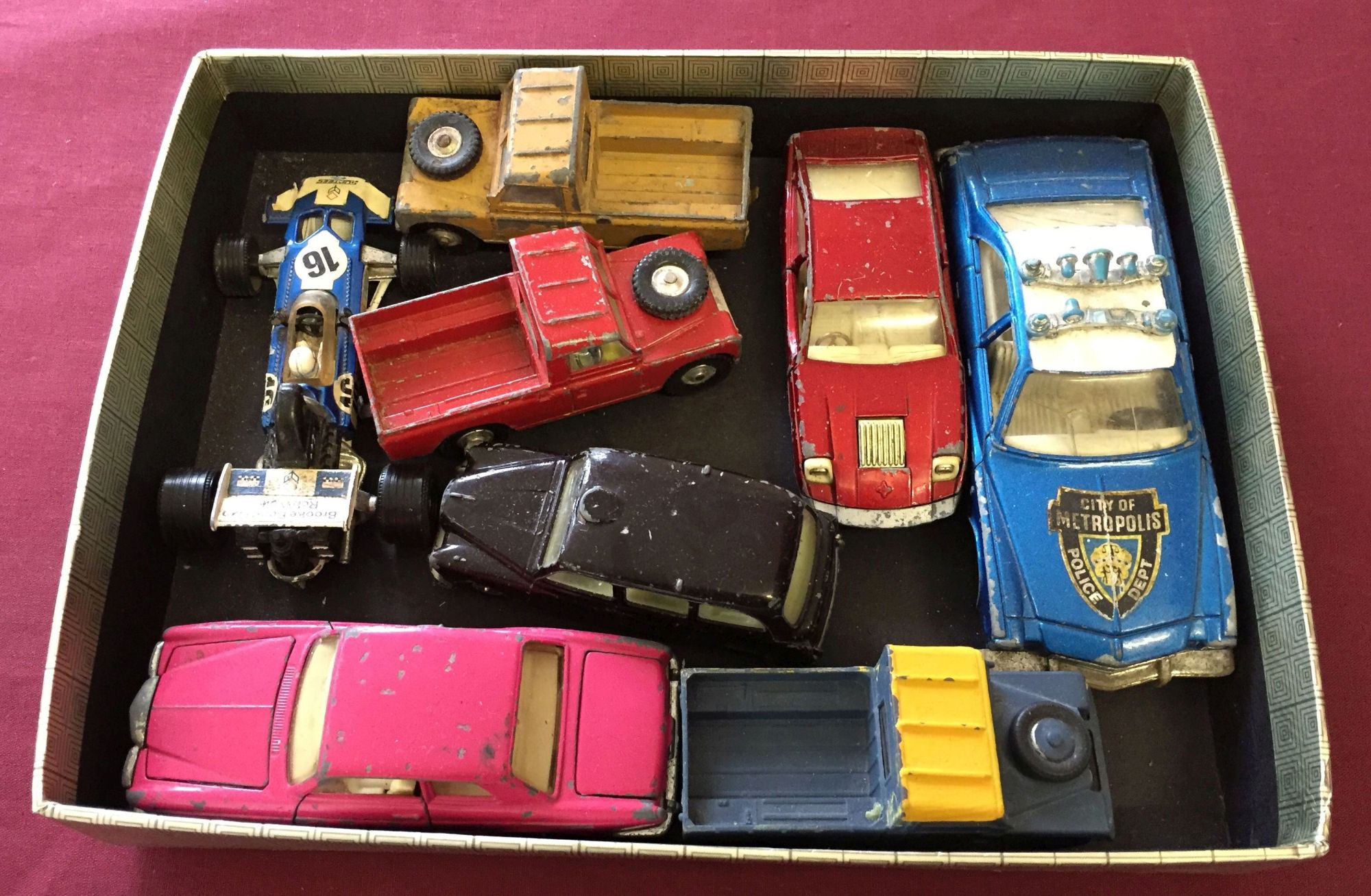 A small tray of assorted Corgi vehicles, playworn and unboxed, to include black London Taxi.