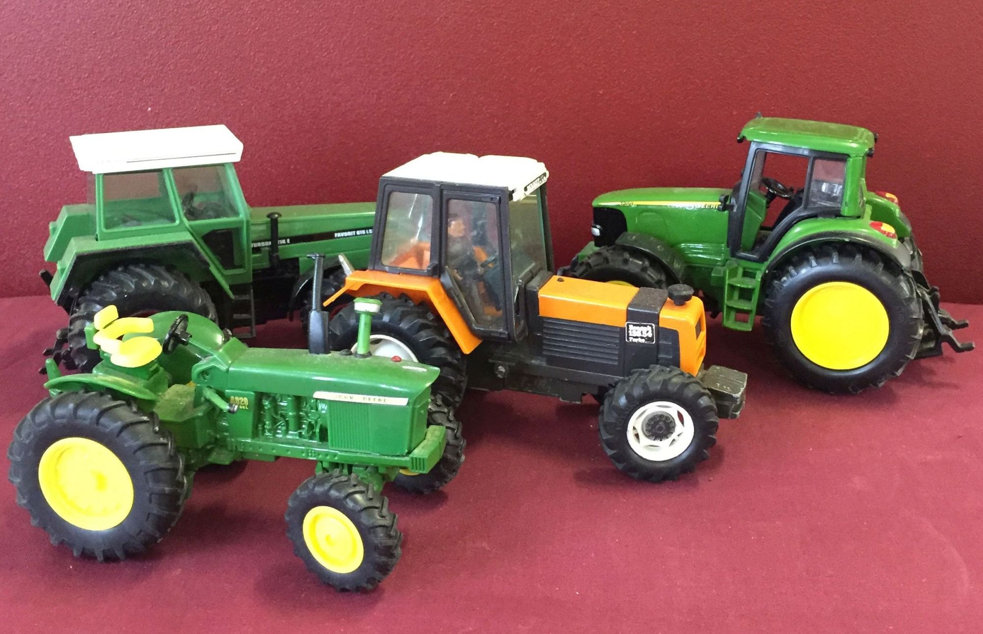 4 toy model tractors to include John Deere