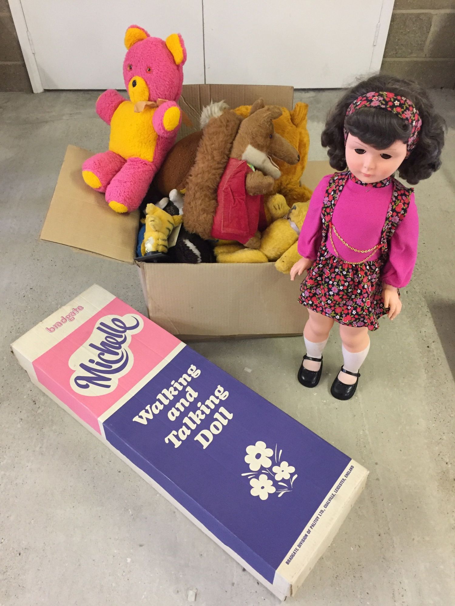 A boxed Palitoy "Michelle" walking & talking doll. 32 inches tall together with a box of soft toys