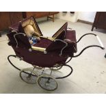 A vintage maroon Pedigree dolls pram c1950-60s with Jesmar doll.