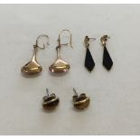 3 pairs of yellow metal earrings. One pair teardrop style, one pair drops set with onyx, and a