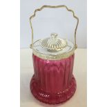 A cranberry coloured glass biscuit barrel.