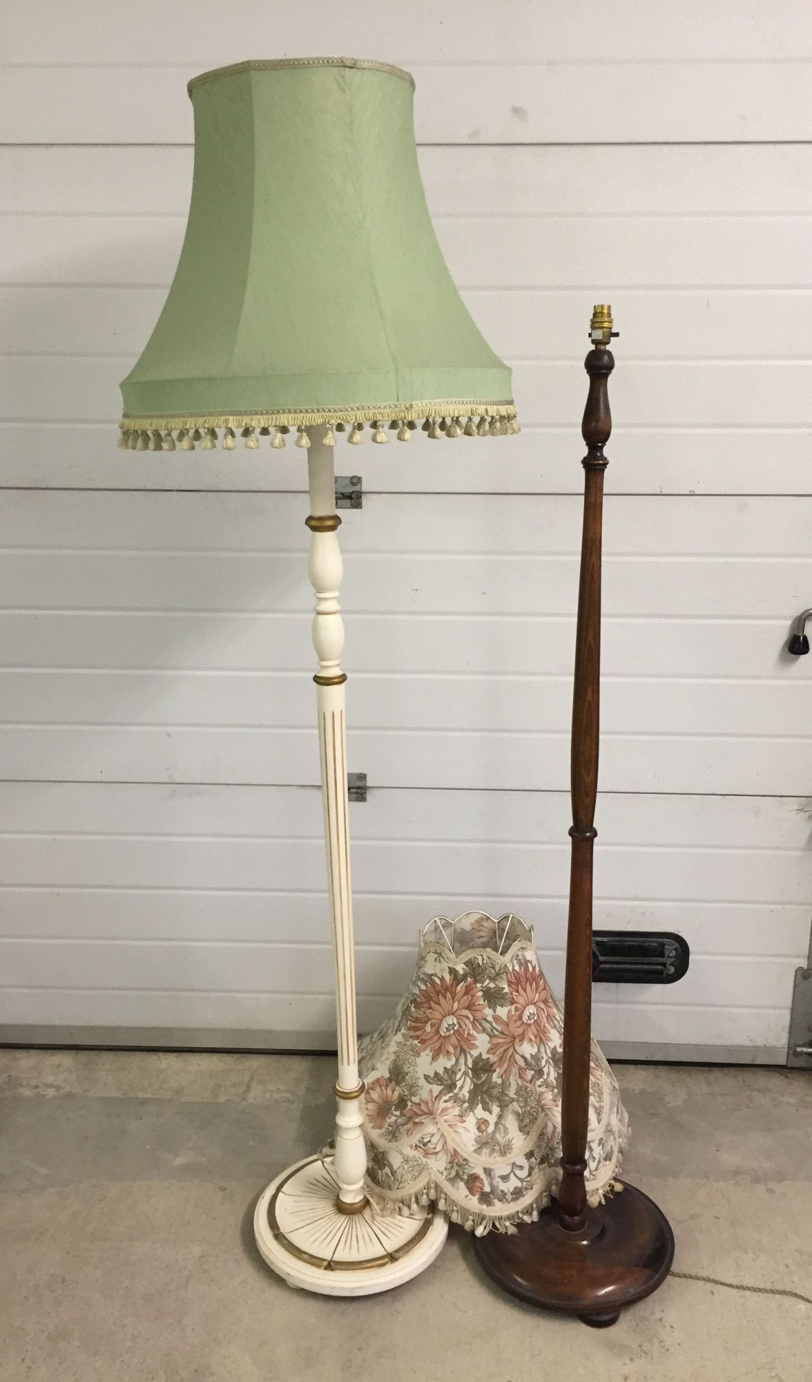 A white and gold standard lamp together with a mahogany standard lamp with round base.