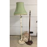 A white and gold standard lamp together with a mahogany standard lamp with round base.