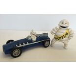 Reproduction cast iron 'Michelin Man' figure and Michelin Man in a blue car.